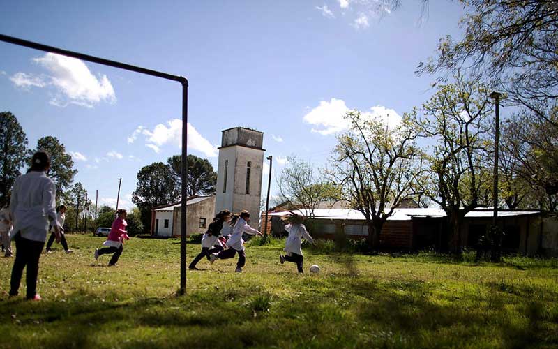 students-play-soccer-during-recess-at-a-rural-school